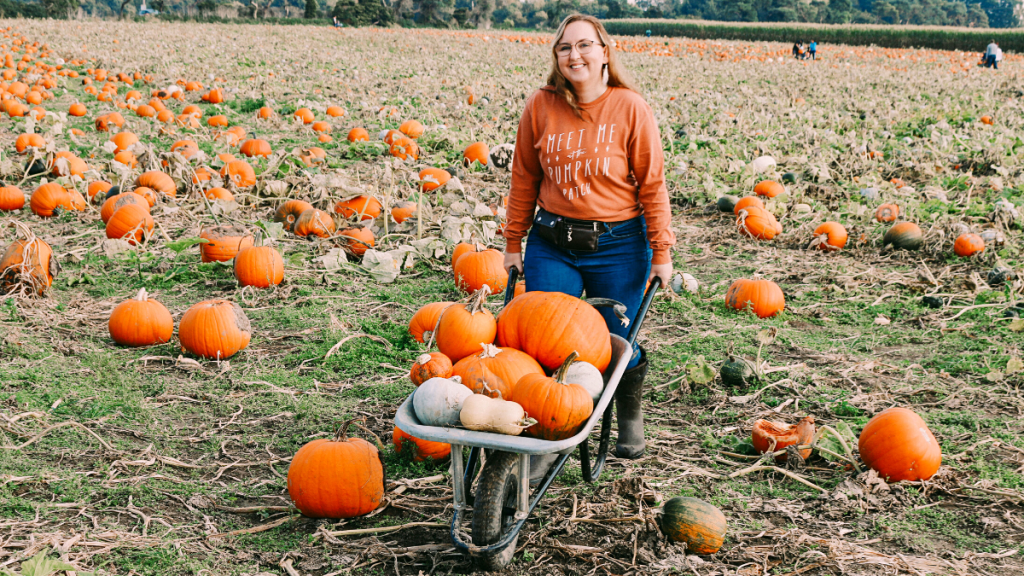 Mel at the pumpkin patch in pumpkin tee