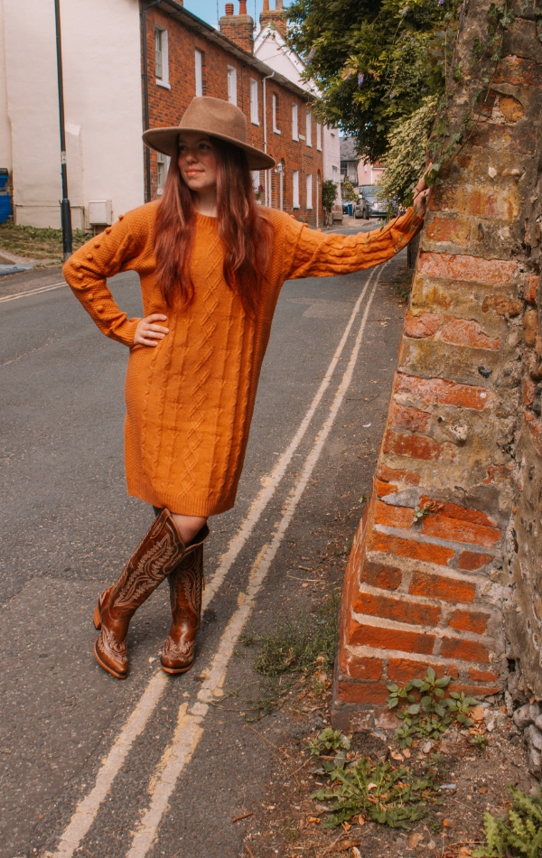 pumpkin coloured jumper dress and cowboy boots